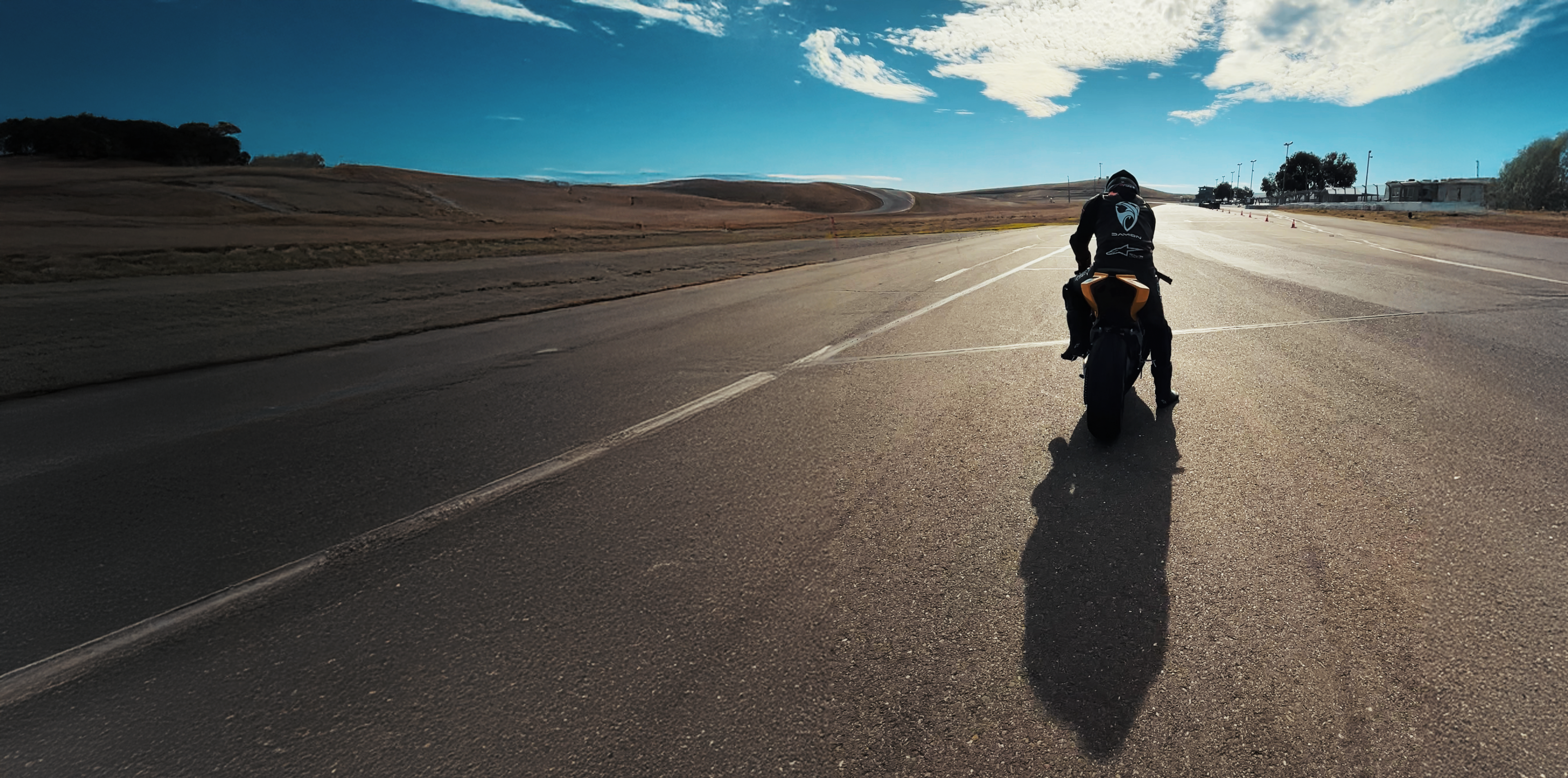 Rider accelerating on a closed course at sunrise