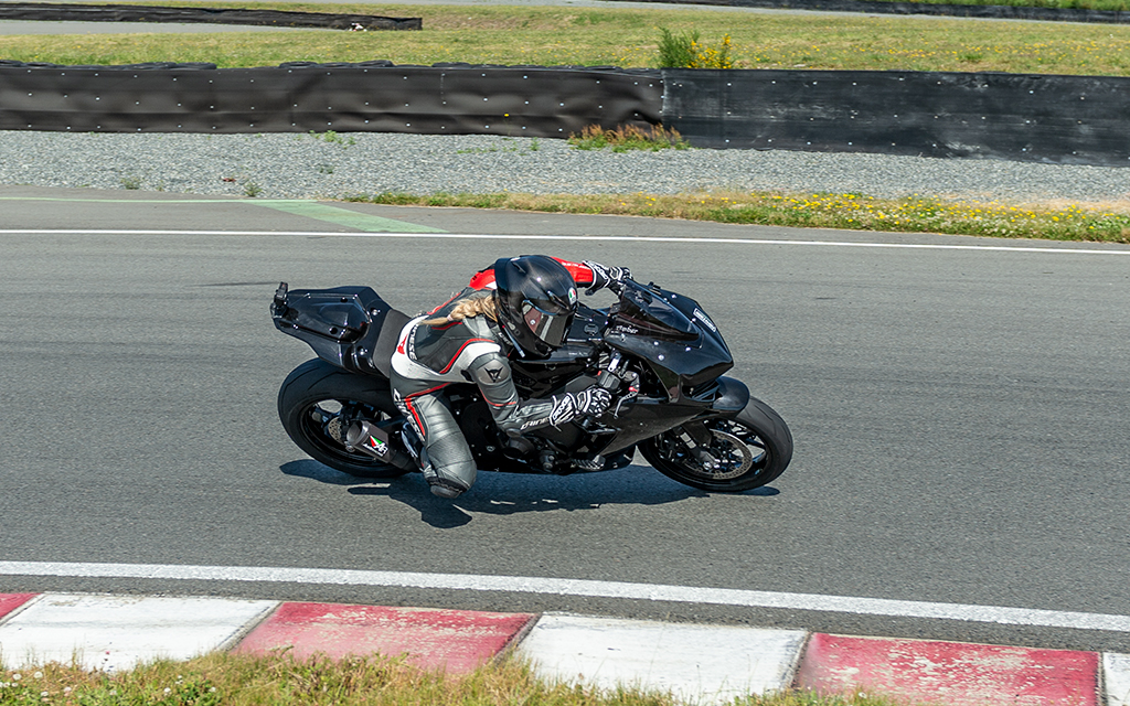 amber spencer riding a black bike on the track