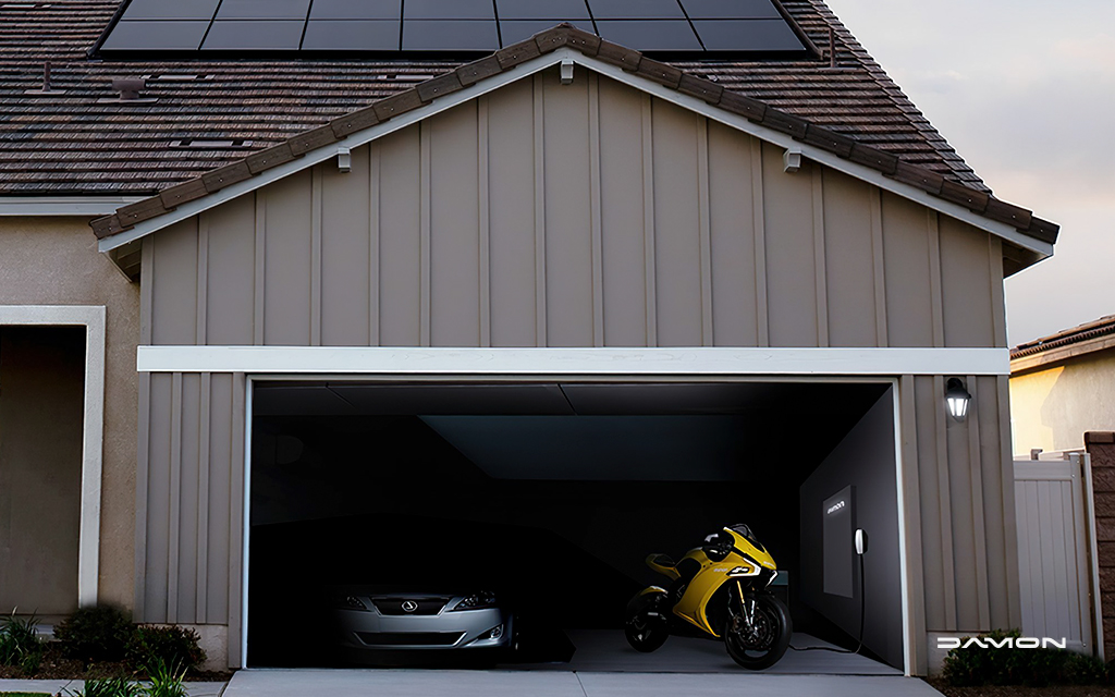damon hypersport hs charing in a garage next to a car