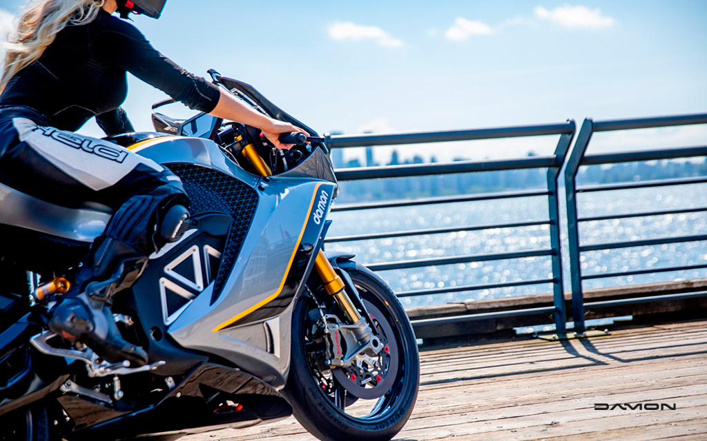 damon hypersport premier with female rider by the sea