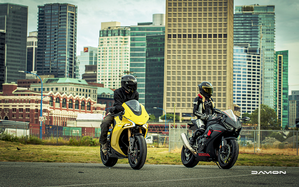 one gold damon hypersport hs gold and one black hongo motorcycle parked in vancouver