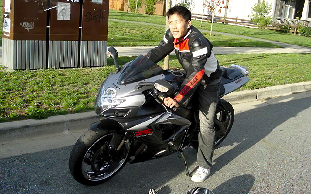 Mike Tan, VP of Finance, on a black motorcycle