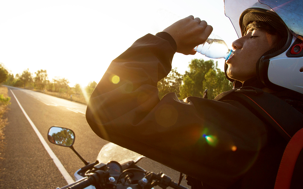 motorcycle rider drinking a bottle of water