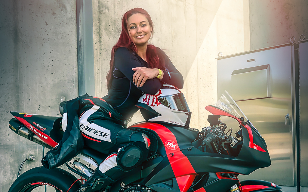 Redspade sitting on her motorcycle