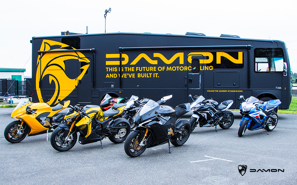 seven sport motorcycles in front of a damon motorcycles rv