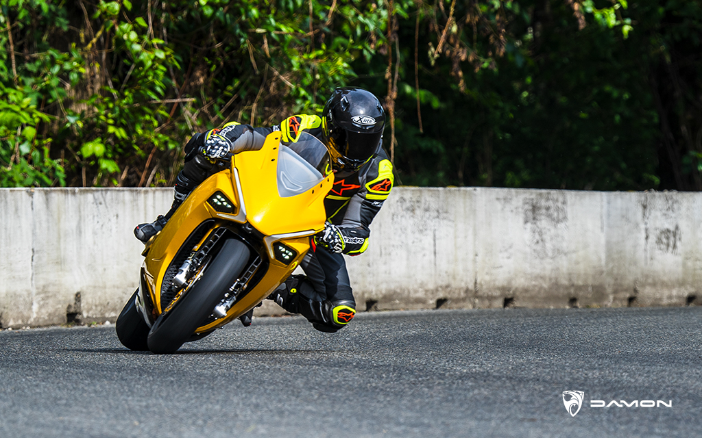 rider cornering on a track with a gold damon hypersport