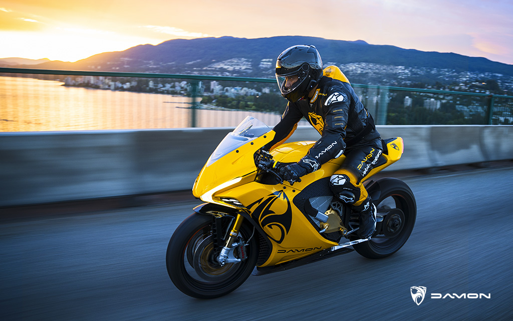 Dom Kwong Riding a Damon HyperSport HS in Damon Gold across a bridge in Vancouver